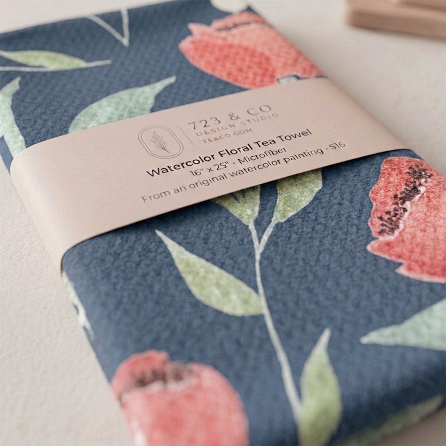 Midnight Blooms tea towel folded with 723 & Co. Design Studio belly band packaging — dark floral watercolor kitchen linen