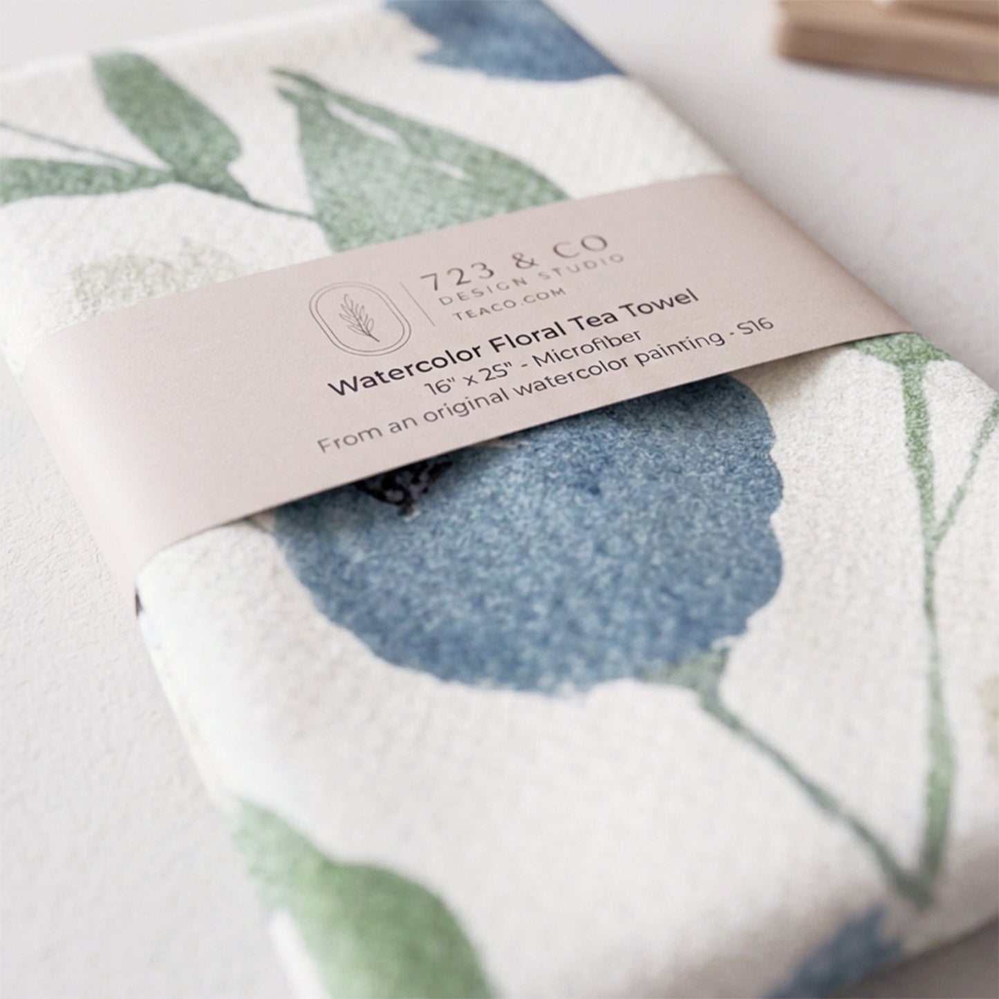 Indigo Garden tea towel folded with 723 & Co. Design Studio belly band packaging — blue botanical kitchen linen
