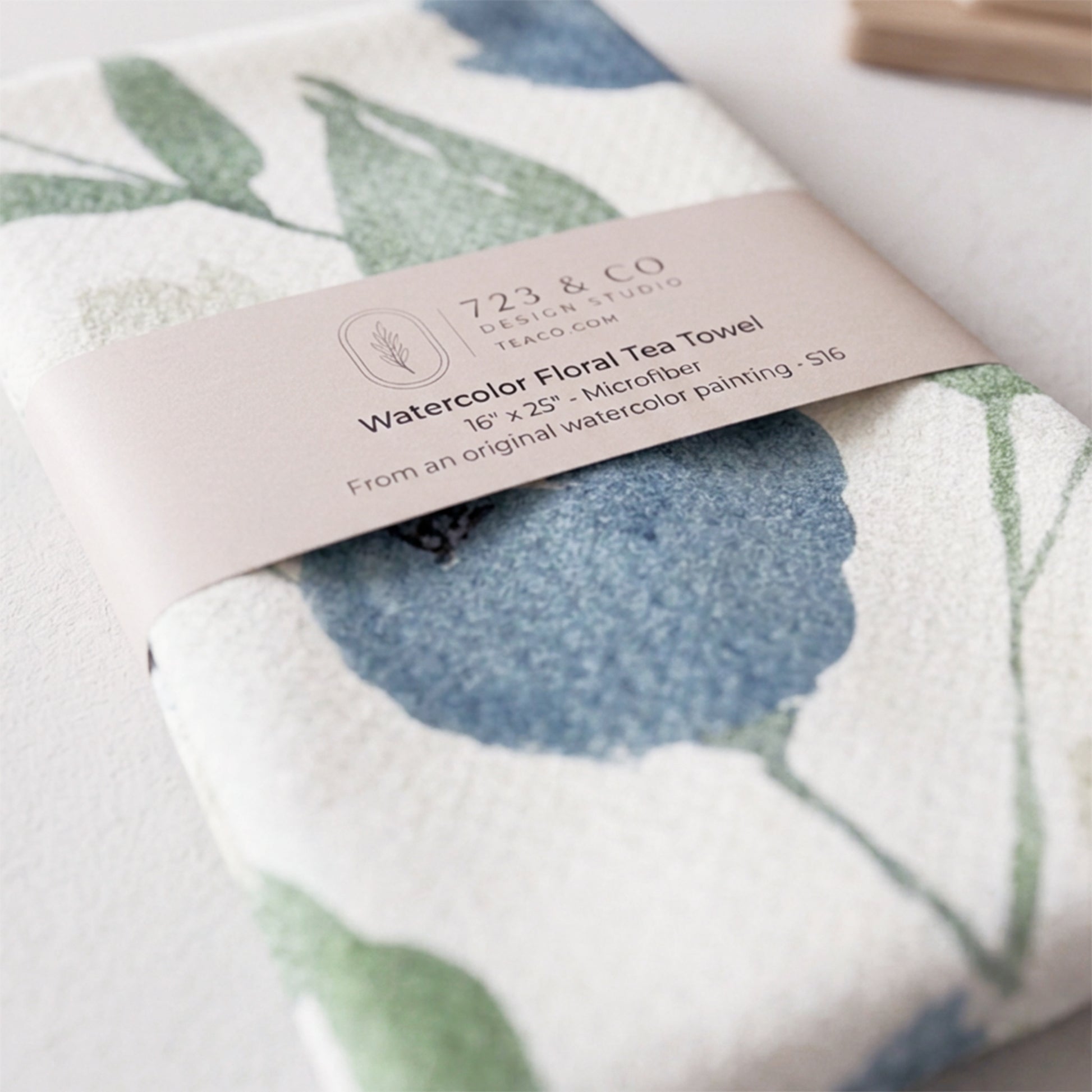 Indigo Garden tea towel folded with 723 & Co. Design Studio belly band packaging — blue botanical kitchen linen
