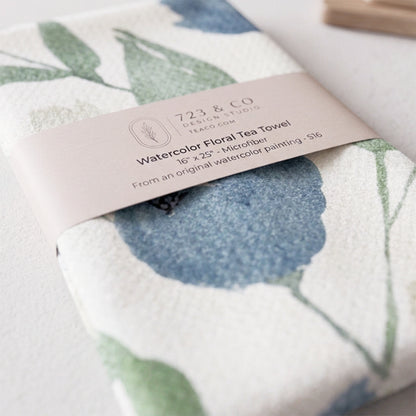 Indigo Garden tea towel folded with 723 & Co. Design Studio belly band packaging — blue botanical kitchen linen
