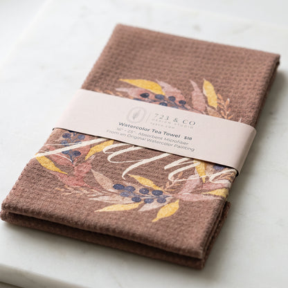 Gather tea towel folded with 723 & Co. Design Studio belly band packaging — autumn wreath watercolor kitchen linen
