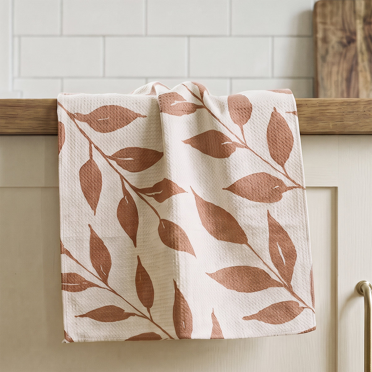 Harvest Wild Leaves watercolor tea towel draped in kitchen setting, warm terracotta botanical leaf linen by 723 & Co. Design Studio
