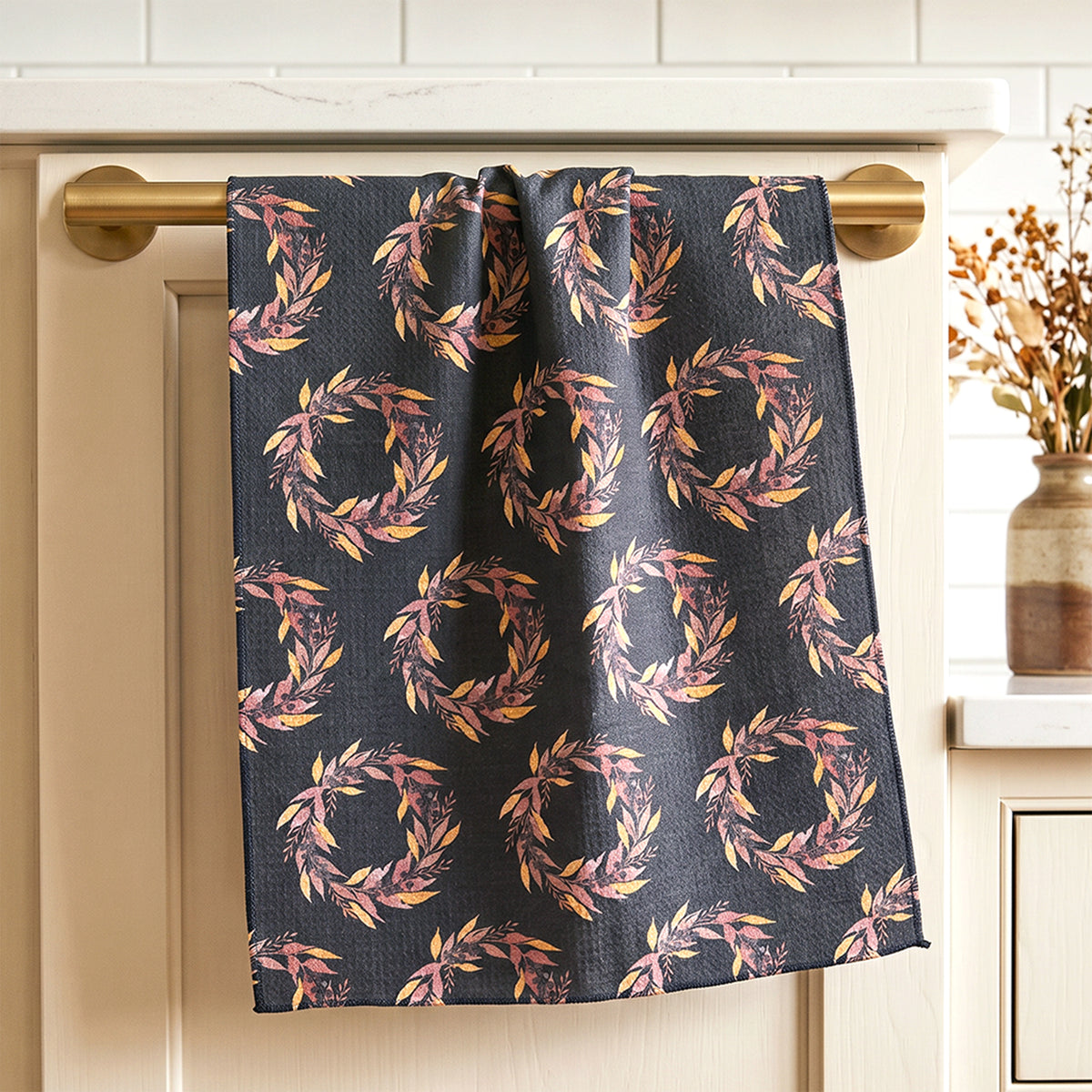 Harvest Wreath watercolor tea towel draped over warm oak cabinet with brass knob — fall kitchen linen by 723 & Co. Design Studio 