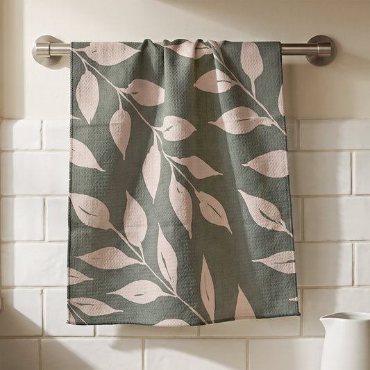 Sage Wild Leaves watercolor botanical tea towel hanging in kitchen setting with natural wood and white tile, 723 & Co. Design Studio