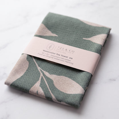 Sage Wild Leaves tea towel folded with 723 & Co. Design Studio belly band packaging, watercolor botanical kitchen linen